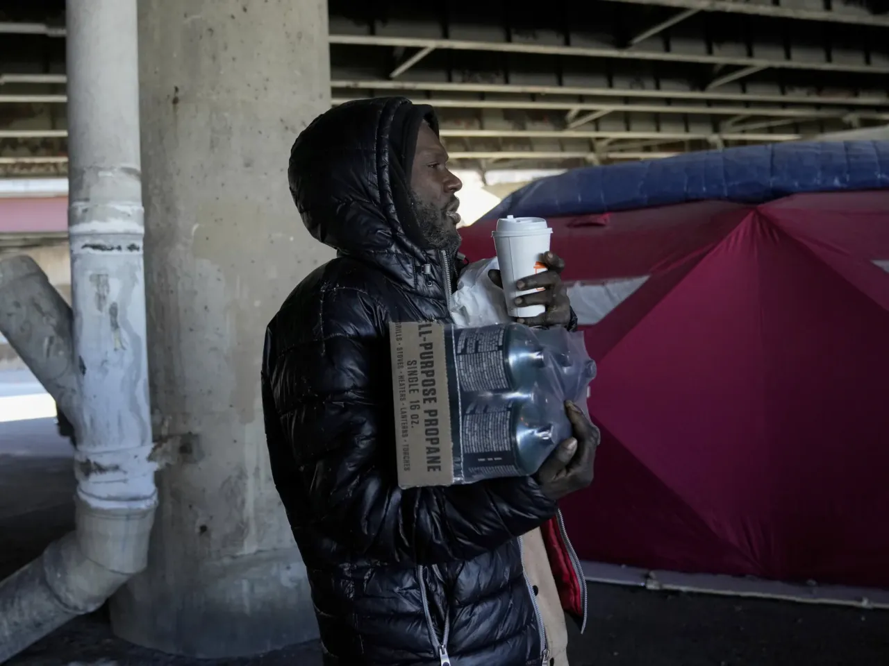 As the winter storm rages, here's what to know in your state 2 Unhoused individual Minyon McClure carries propane and other supplies from the Orange Tent Project nonprofit during dangerously cold temperatures Friday, Jan. 23, 2026, in Chicago.