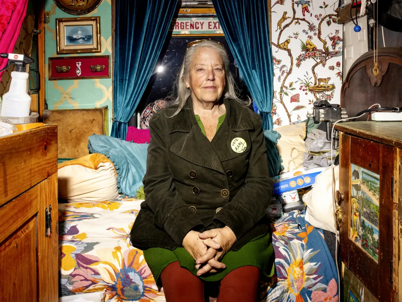 Mary Freuer sits inside of her teal school bus.