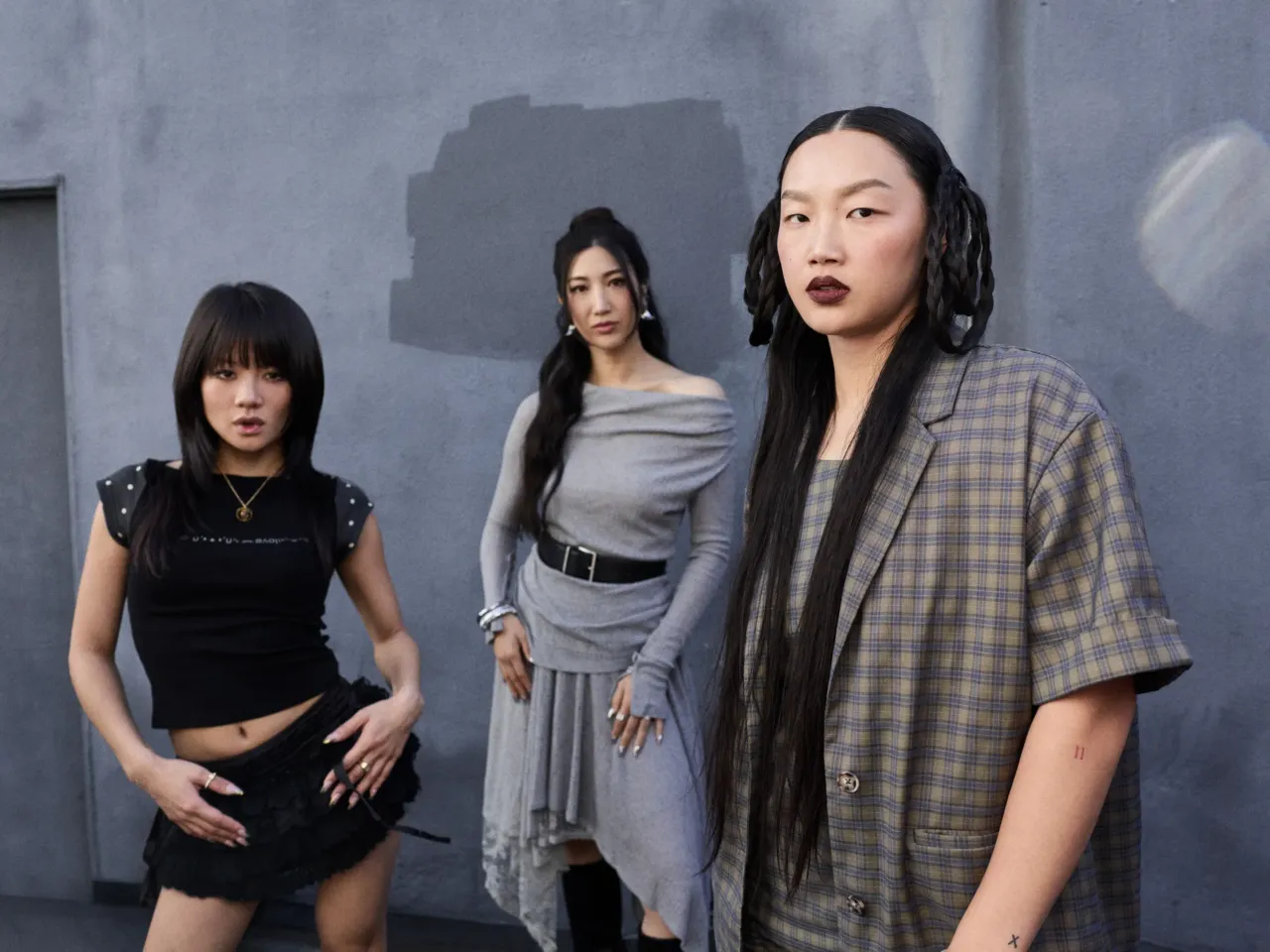 Artists Rei Ami (left), EJAE and Audrey Nuna are behind the singing voices of the fictional girl group HUNTR/X in KPop Demon Hunters.