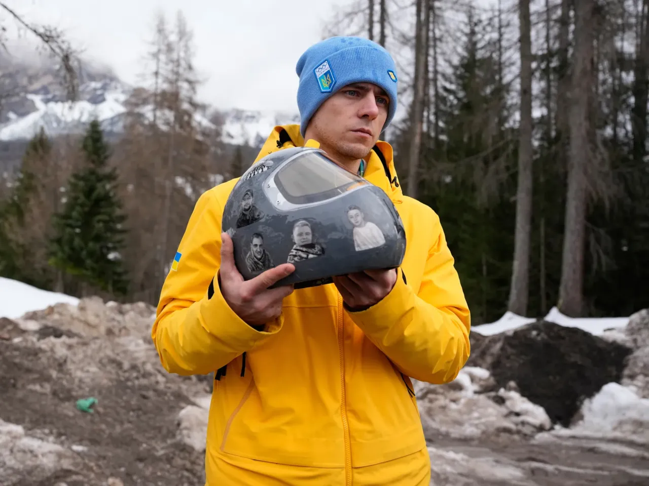 Ukrainian skeleton athlete Vladyslav Heraskevych holds his crash helmet as he stands outside the sliding center at the 2026 Winter Olympics, in Cortina d'Ampezzo, Italy, Thursday.