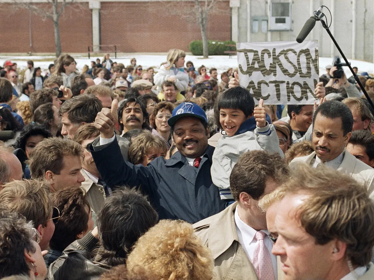 Democratic presidential hopeful Rev. Jesse Jackson and Larry Estoda, 8, give a thumbs up at a Jackson for President rally in Greeley, Colo., on April 2, 1988.