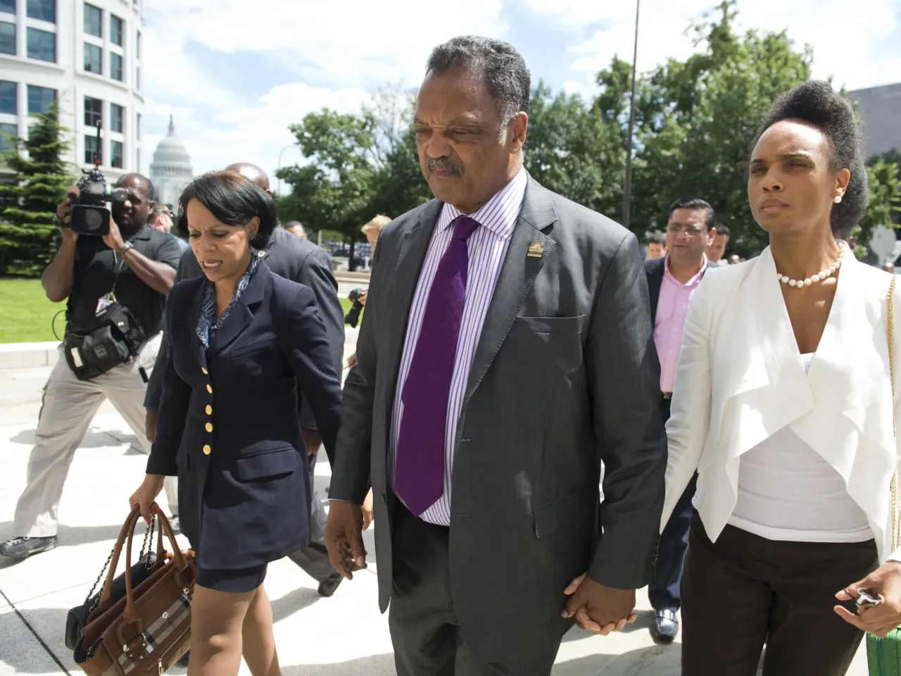 Rev. Jesse Jackson Sr. walks away after speaking to the media following a sentencing hearing for his son, former Illinois Congressman Jesse Jackson Jr., and his wife, Sandi Jackson, at the U.S. District Court in Washington, DC, on Aug. 14, 2013. Jackson Jr. was sentenced to 30 months in prison and his wife, Sandi, received a year sentence for separate felonies involving the misspending campaign funds.