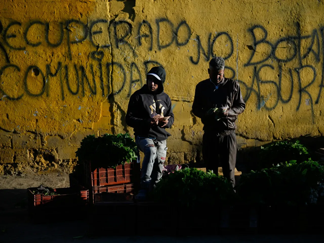 Vendors sell vegetables at an open market in Caracas, Venezuela, Jan. 21, 2026.