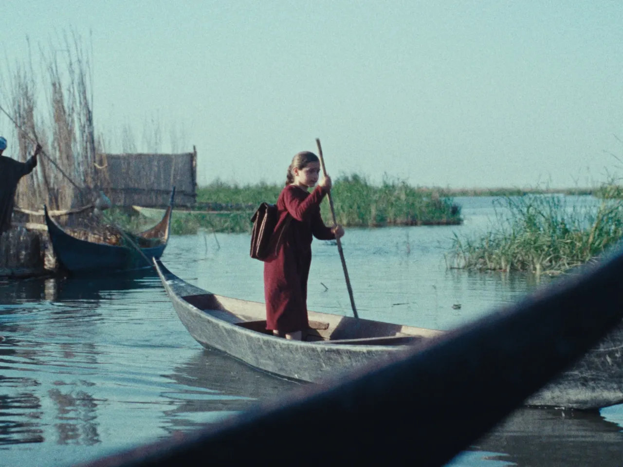 Lamia (Baneen Ahmed Nayyef) rows through Mesopotamian marshlands from her home to school.