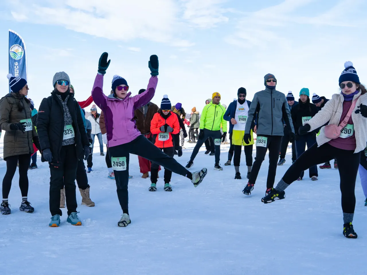 This community festival embraces the joys of a frozen lake — while it still has one 3 Runners warm up before the annual Frozen Assets Festival's 5K.