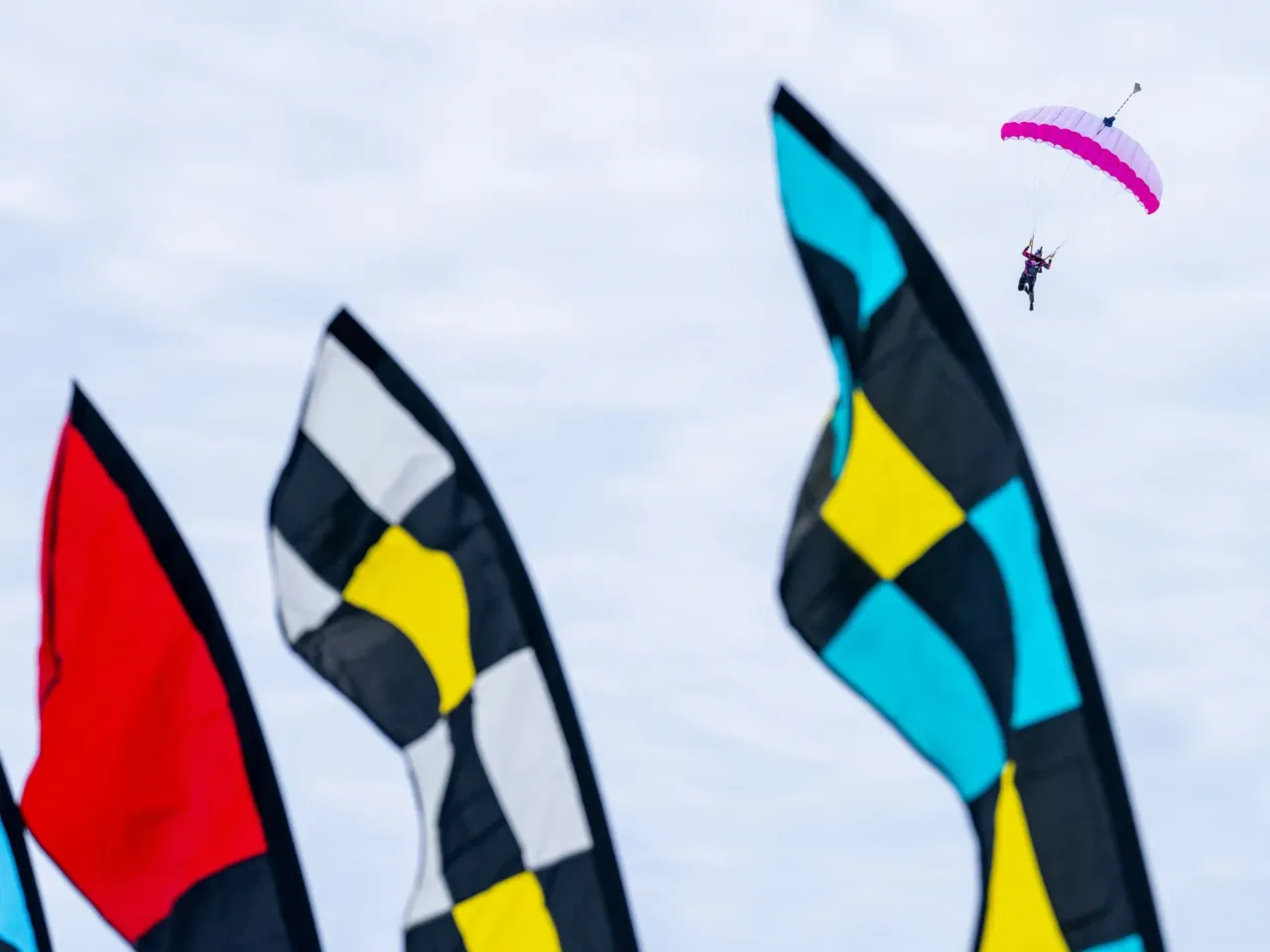 This community festival embraces the joys of a frozen lake — while it still has one 10 A skydiver glides through the air during the Frozen Assets Festival above Lake Mendota and Madison, Wis., on Saturday, Feb. 7.