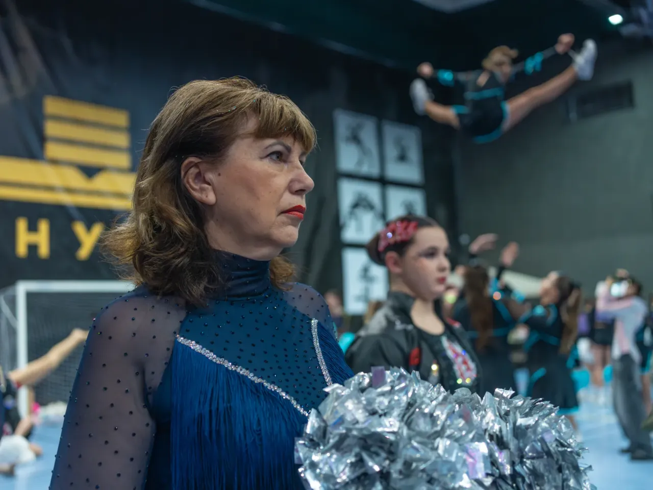 Accountant Halyna Plakhuta, 63, had a bad arm and shaky knees when she joined the Sunrise cheerleading squad. She had been a full-time caretaker during the war and had grown physically fragile. "Now I jump so high, my granddaughter is impressed," she says.