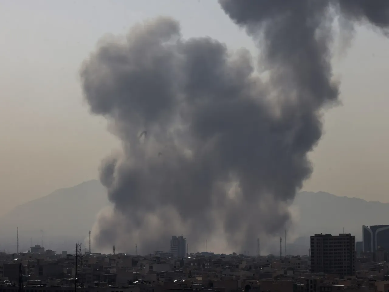 Lawmakers divided over Iran strikes, launched without approval from Congress 1 A plume of smoke rises following a reported explosion in Tehran on Saturday after U.S. and Israel launched strikes on Iran.