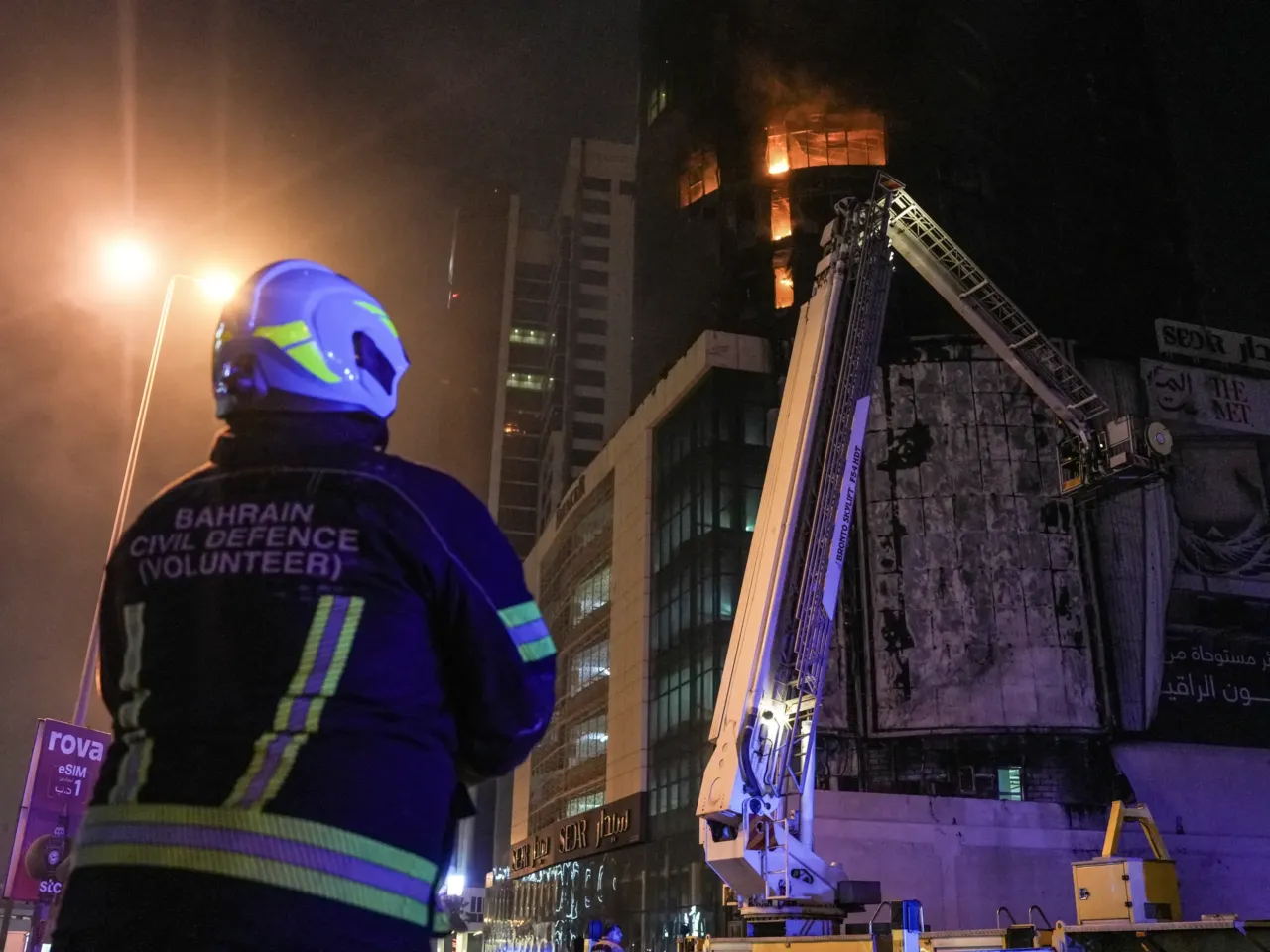 Emergency personnel work to extinguish a building fire in Manama, Bahrain on February 28, 2026. The fire was the result of retaliation strikes by Iran, following the coordinated attacks by the United States and Israel.