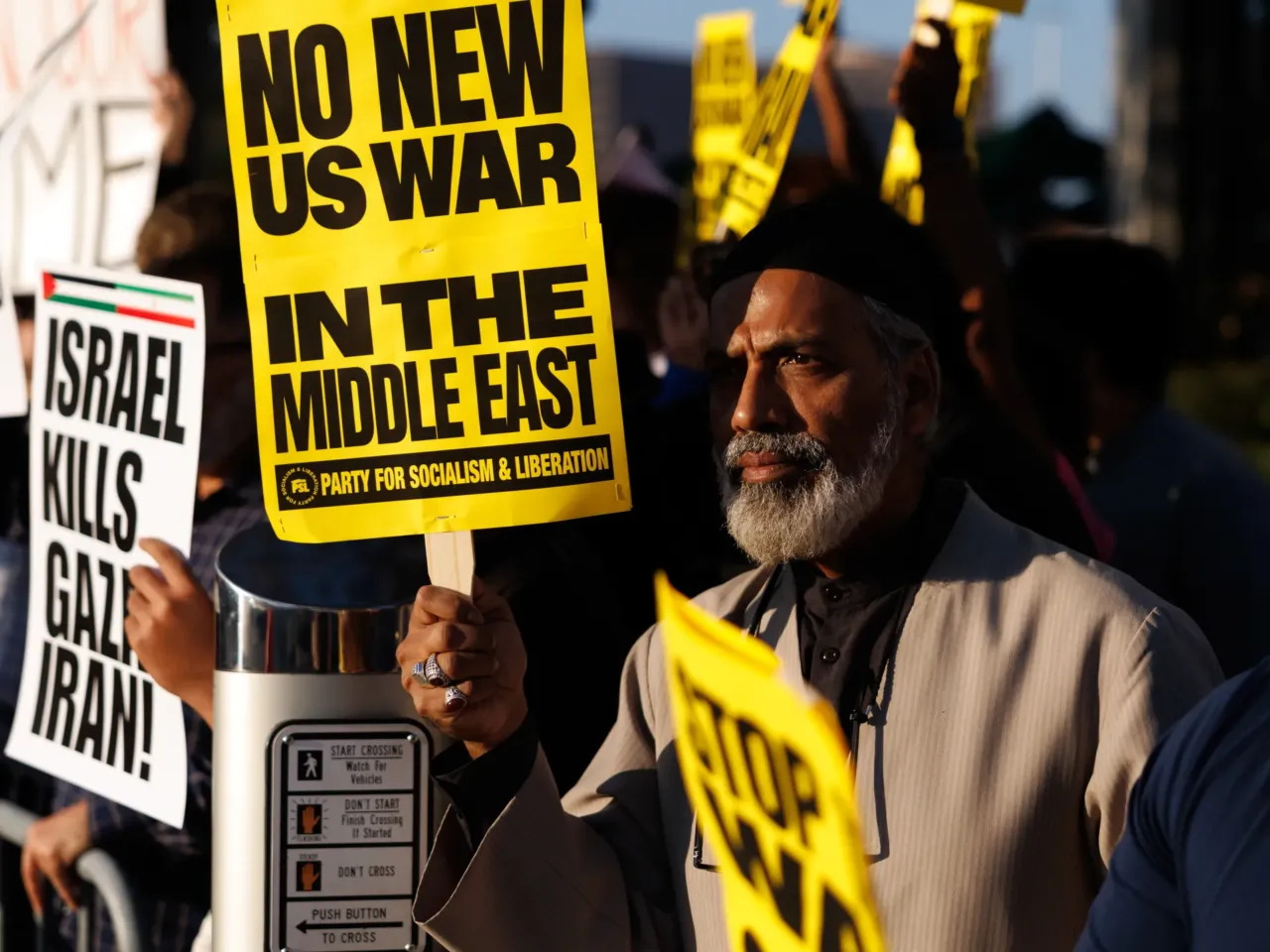 Demonstrators hold a sign reading "No New US War In The Middle East" during a protest against war in Iran in Houston, Texas, US, on Saturday, Feb. 28, 2026.