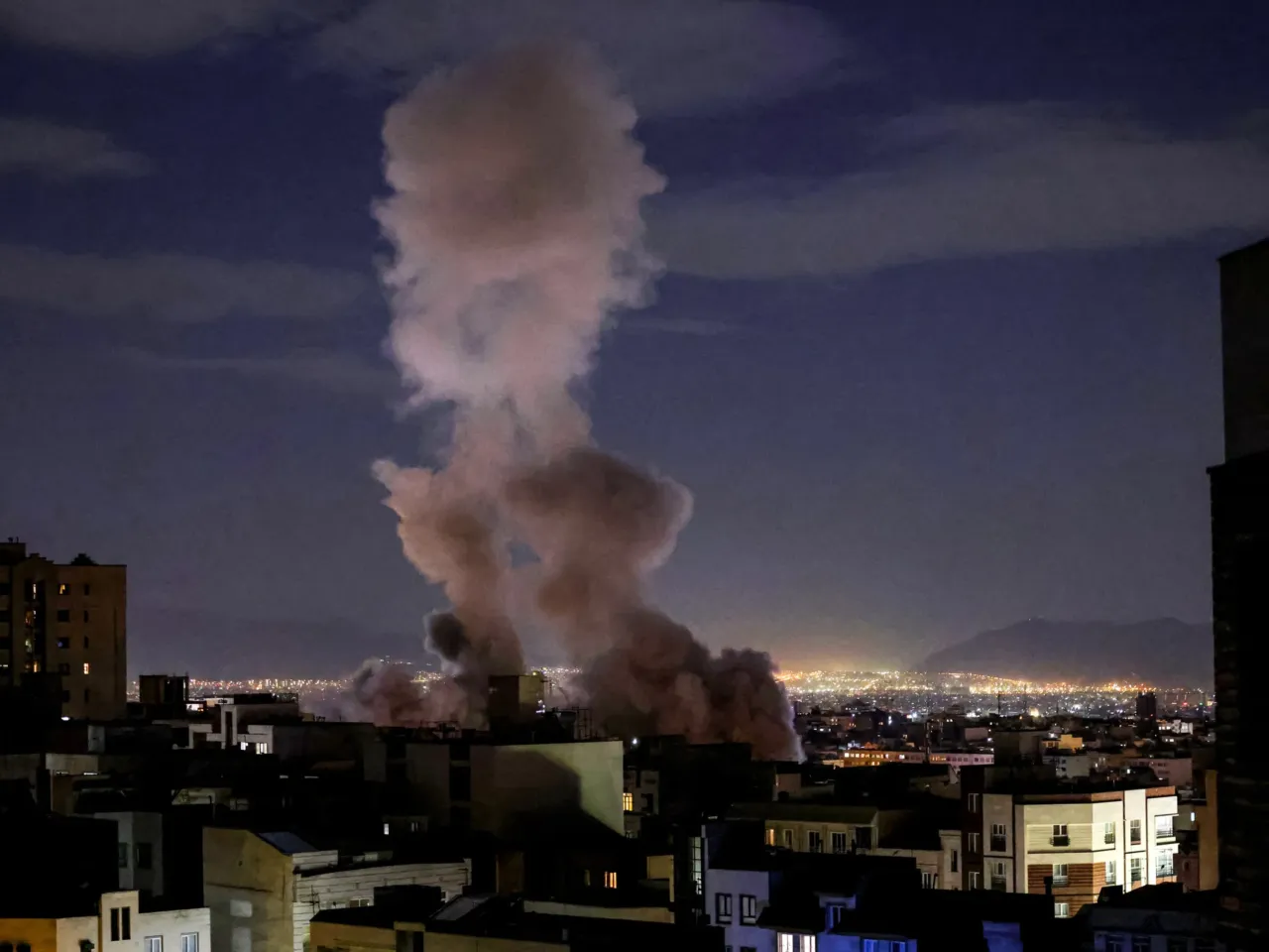 A smoke plume rises following a missile strike on a building in Tehran on March 1, 2026.