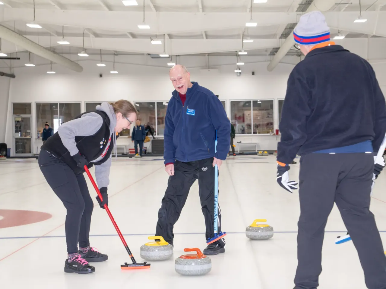 Howard Griffin laughs while playing with other members of the Potomac Curling Club. He has been curling for over 20 years.