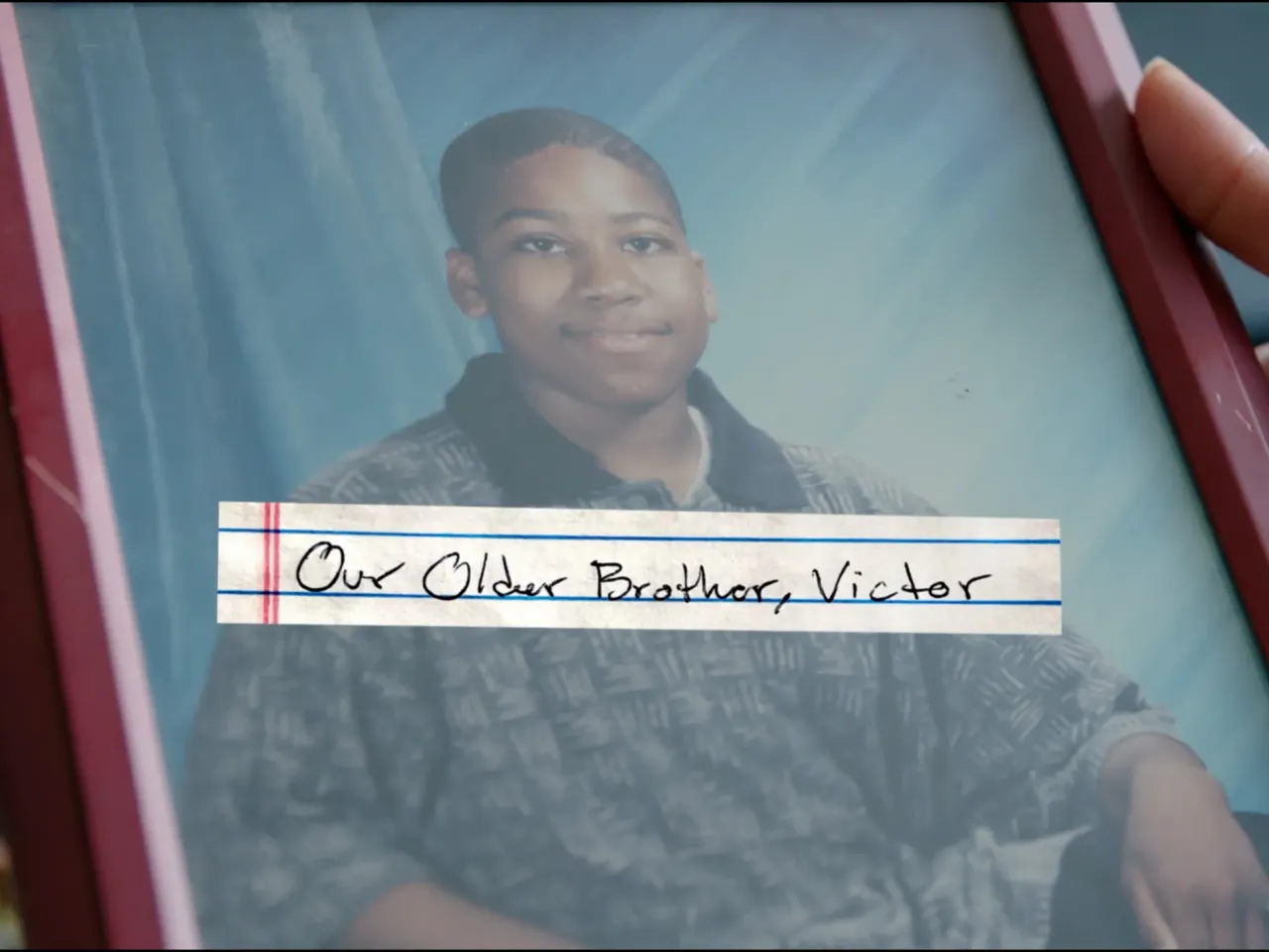 Reneasha Jacobs holds a photograph of her and James' older brother, Victor Benjamin. Benjamin was shot and killed on April 19, 2004.