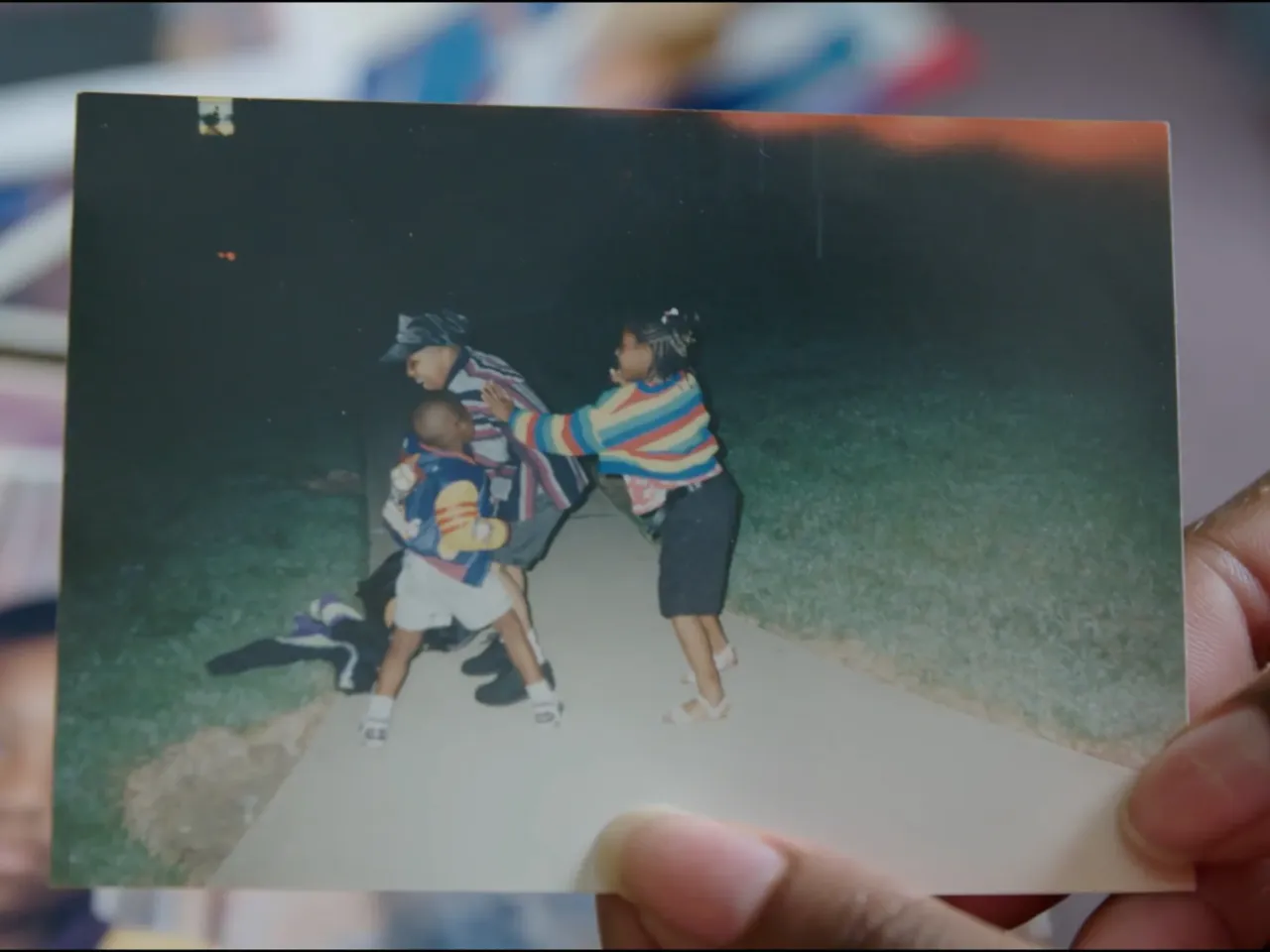 Reneasha Jacobs, James' older sister, holds an old photograph of herself and her two brothers from when they were kids. James shot and killed someone on April 16, 2004. Three days later, their older brother was murdered.