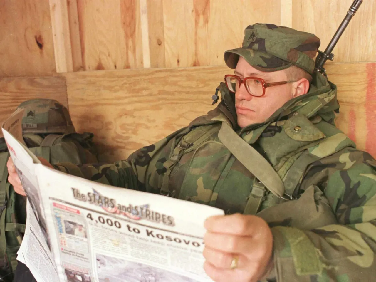 US soldier Sgt. John Hubbuch of Versailles, Ky., one of the members of NATO led-peacekeeping forces in Bosnia reads Stars and Stripes newspaper on Sunday Feb. 14, 1999.