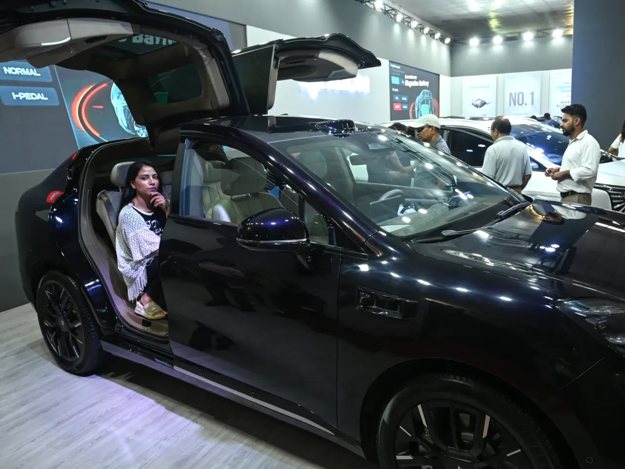 In this photograph taken on September 1, 2024, visitors look at electric vehicles in Kathmandu. More than 70% of new car sales in Nepal are electric.