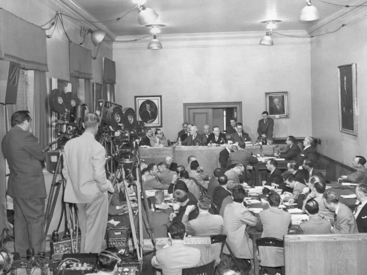 The packed scene in New York City as star witness Frank Costello (at witness table, right background, leaning forward)  testified. Next to Costello is his lawyer, George Wolf. At the committee table are (left to right): Rudolph Halley, chief counsel for the committee; Sen. Charles Tobey (R-N.H.); Sen. Herbert O'Conor (D-Md.); and Sen. Estes Kefauver (D-Tenn.), the committee chairman.
