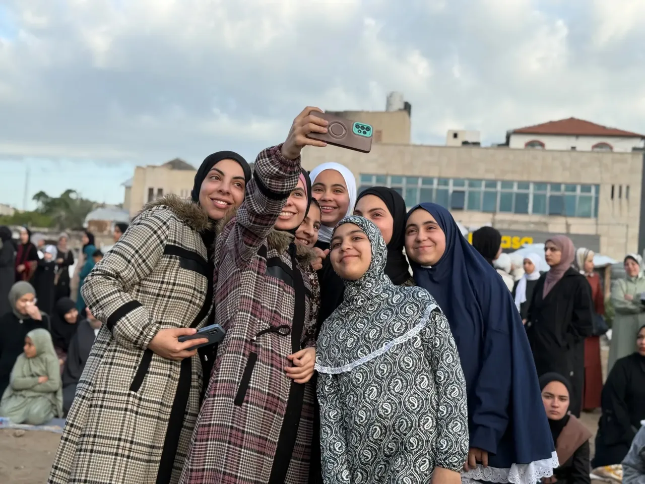 Palestinians celebrate Eid in Gaza, making the most of a fragile ceasefire 2 Young women pose for selfies in Gaza City on Friday.