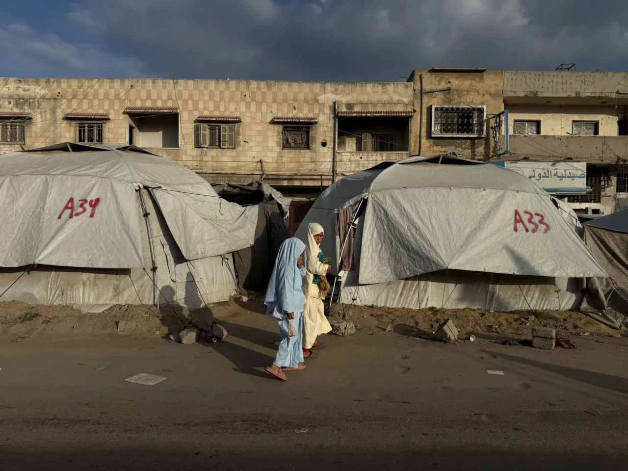 Palestinians celebrate Eid in Gaza, making the most of a fragile ceasefire 7 Girls walk past tents in Gaza City on Friday. For two years of war, Gaza's streets shook with the sound of deadly Israeli airstrikes
