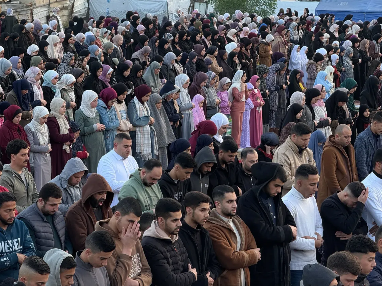 Palestinians celebrate Eid in Gaza, making the most of a fragile ceasefire 11 People pray on Eid in Gaza City on Friday.