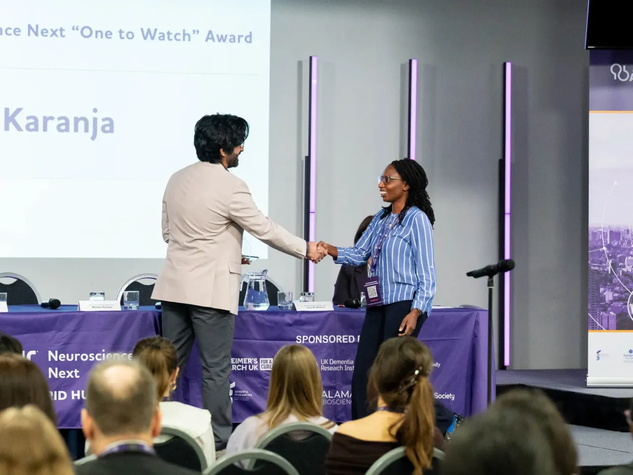 Wambūi Karanja of Kenya accepts the "One to Watch" award from the Alzheimer's Association for the guide she's developed to help family caregivers.