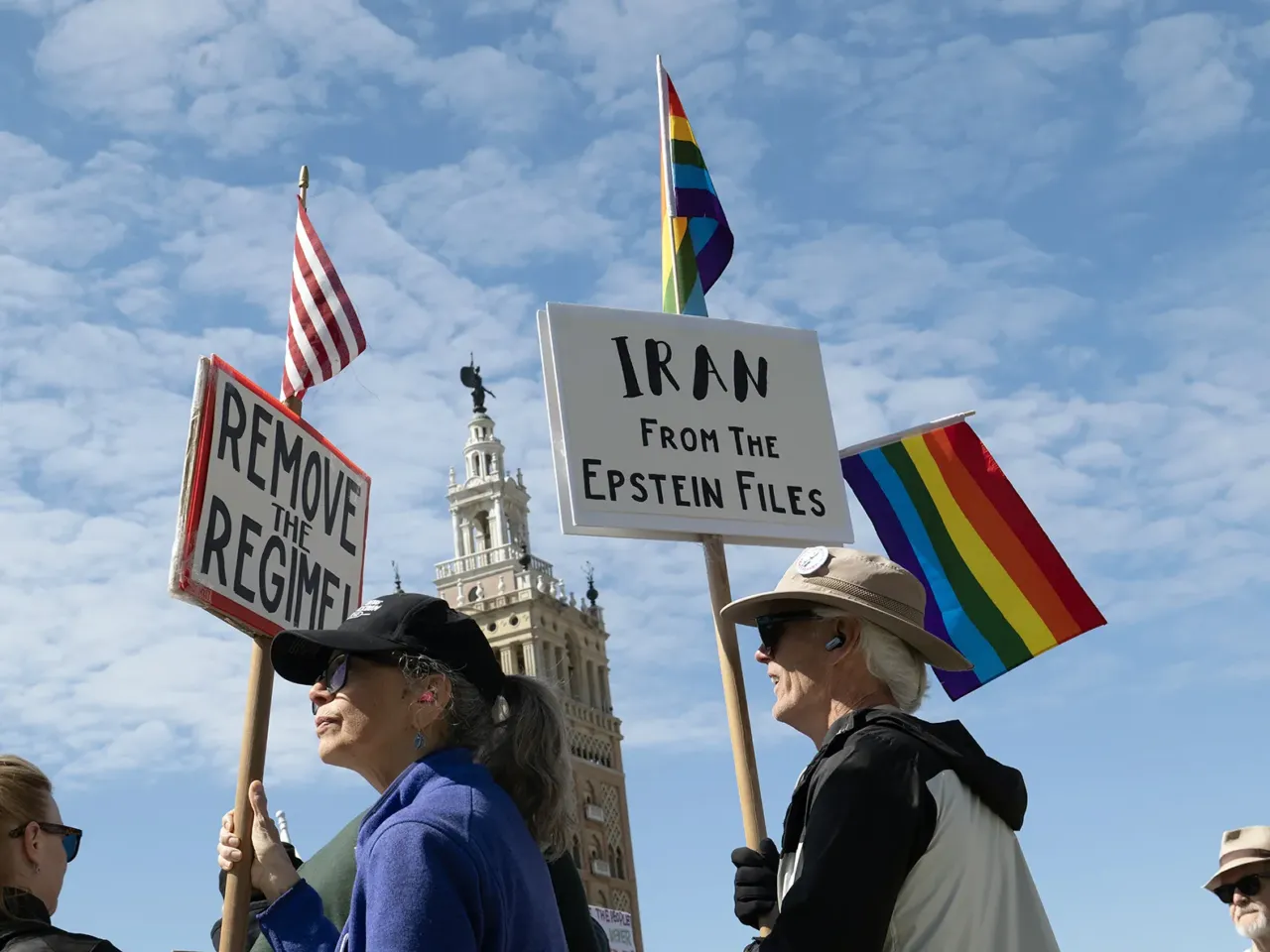 Maria Perry, left, and John Stock, right, joined protesters gathering in Mill Creek Park in Kansas City, Missouri.