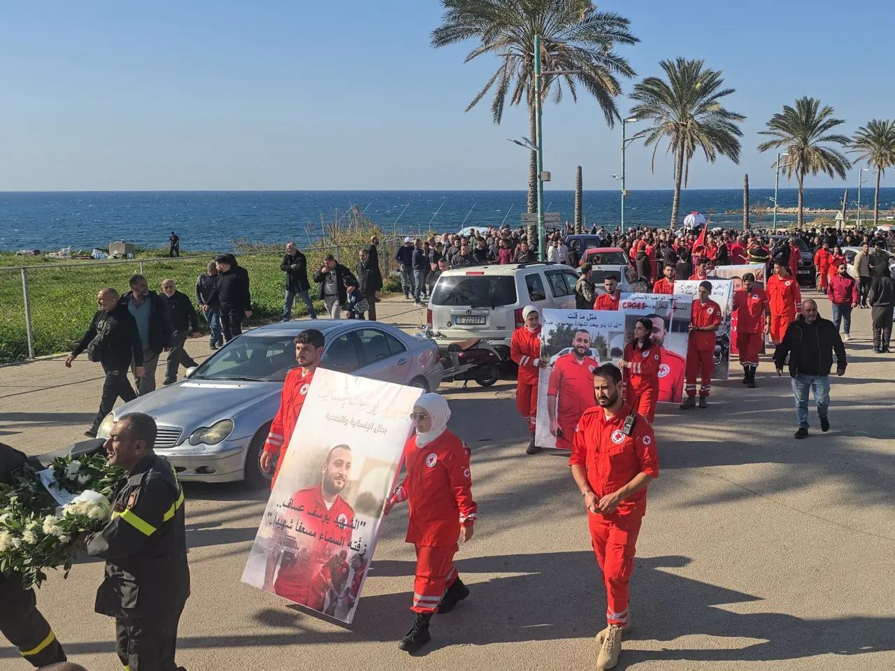 Mourners hold a portrait of Youssef Assaf, a Lebanese Red Cross volunteer paramedic who was killed during a rescue mission in southern Lebanon, at his funeral in Tyre on March 11.