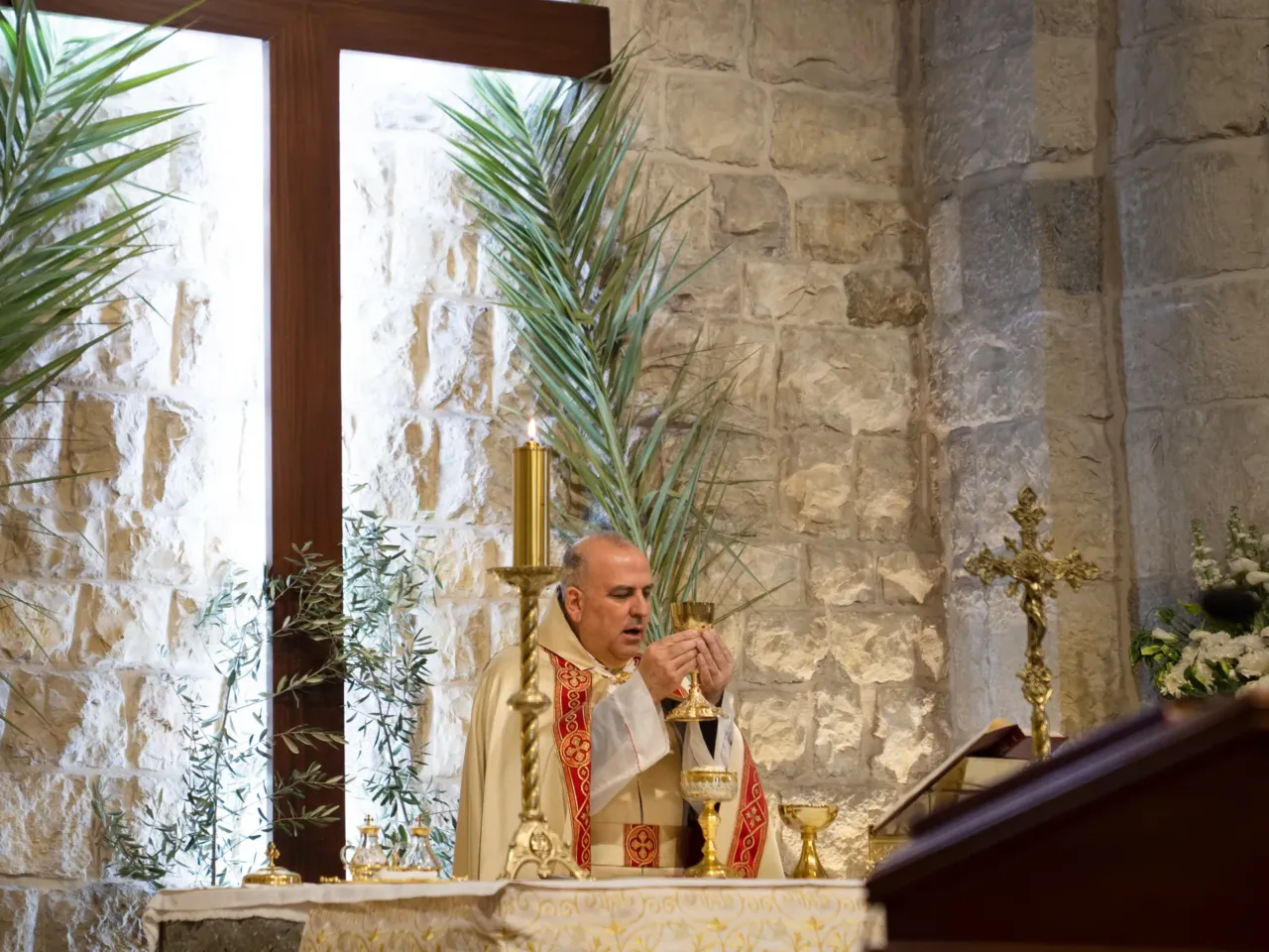 'Not our war' say Christians under siege this Easter, as Israel invades south Lebanon 2 Father Elias El Helou presides over mass on Palm Sunday at St. Maron Church in Jezzine.