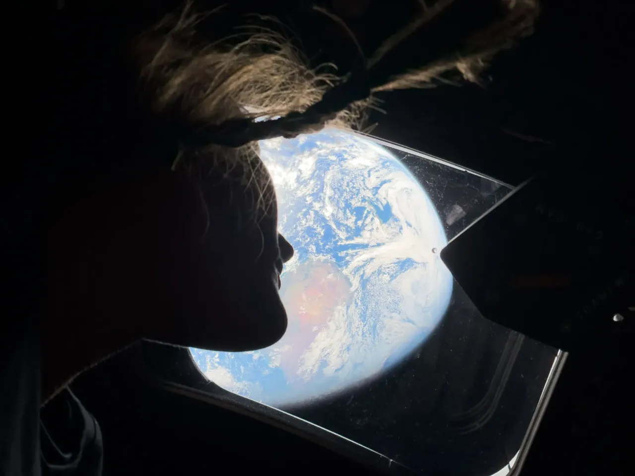 Artemis II astronauts heading home after historic moon flyby 1 NASA astronaut and Artemis II mission specialist Christina Koch peers out of one of the Orion spacecraft's main cabin windows, looking back at Earth on Saturday, as the crew traveled toward the moon.