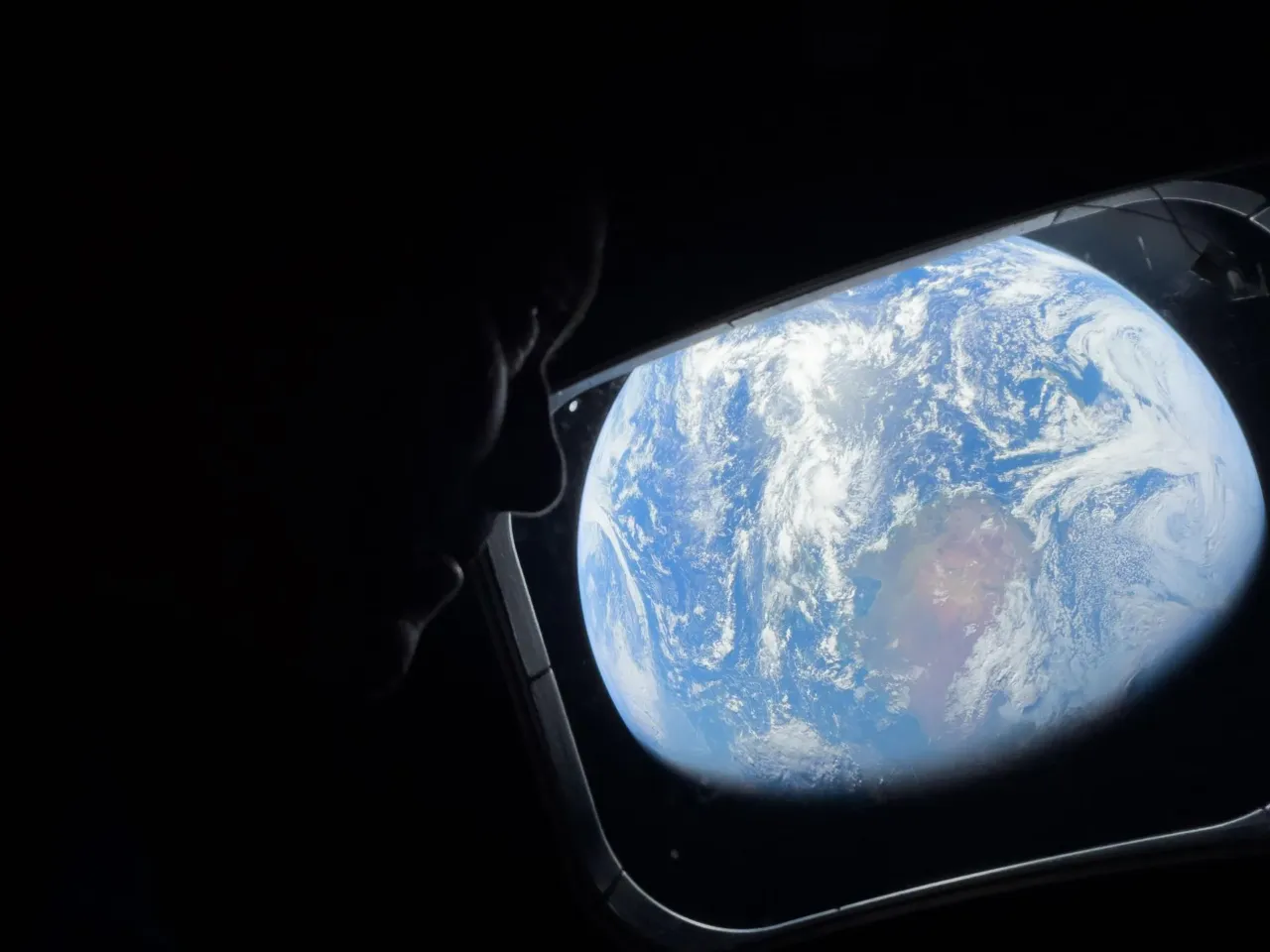 NASA astronaut and Artemis II Commander Reid Wiseman looks at Earth through Orion's main cabin windows as the crew travels towards the Moon. Wiseman and his three crewmates are set to return to Earth on Friday.