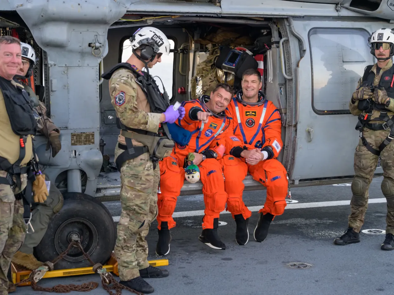Artemis II splashdown captures nationwide attention 3 NASA astronaut Reid Wiseman, Artemis II commander, left, and CSA (Canadian Space Agency) astronaut Jeremy Hansen, Artemis II mission specialist, are seen sitting on a Navy MH-60 Seahawk from Helicopter Sea Combat Squadron (HSC) 23 on the flight deck of USS John P. Murtha.