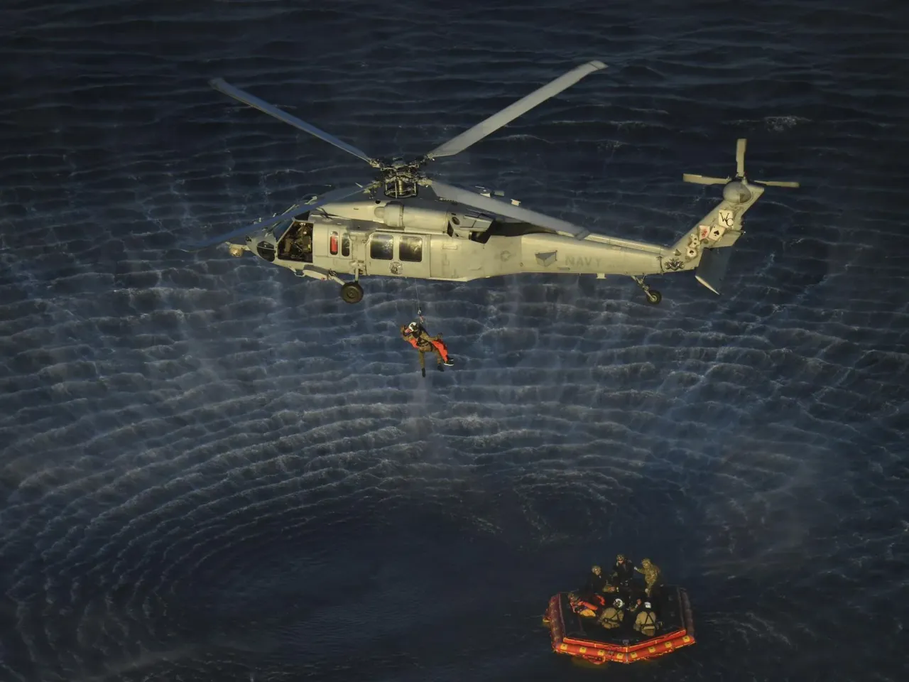 Artemis II splashdown captures nationwide attention 4 U.S. Navy divers and Artemis II astronauts aboard an inflatable raft are approached by helicopters and lifted away to the recovery ship.