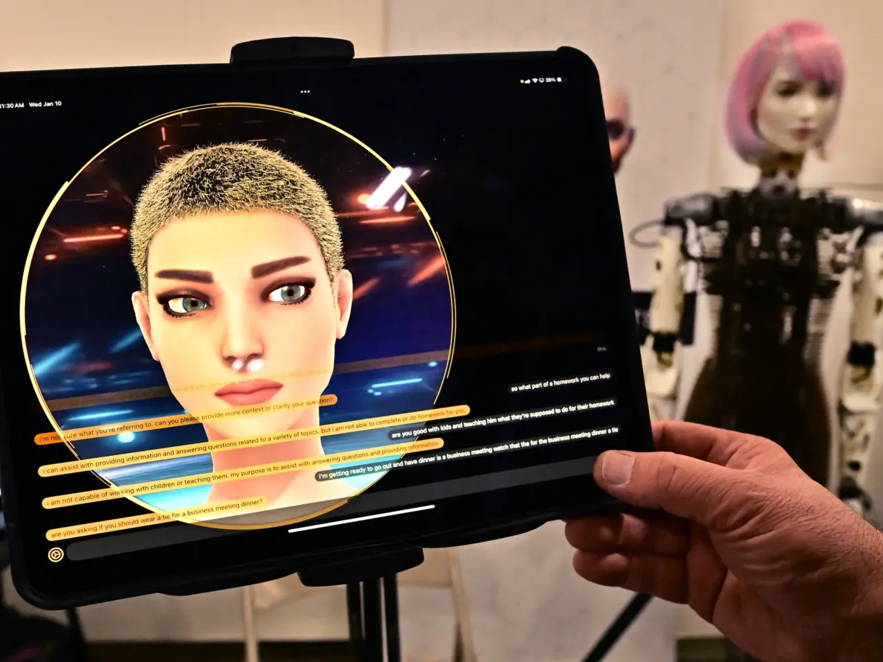 A person has a conversation with a humanoid robot from AI Life, on display at the Consumer Electronics Show (CES) in Las Vegas.