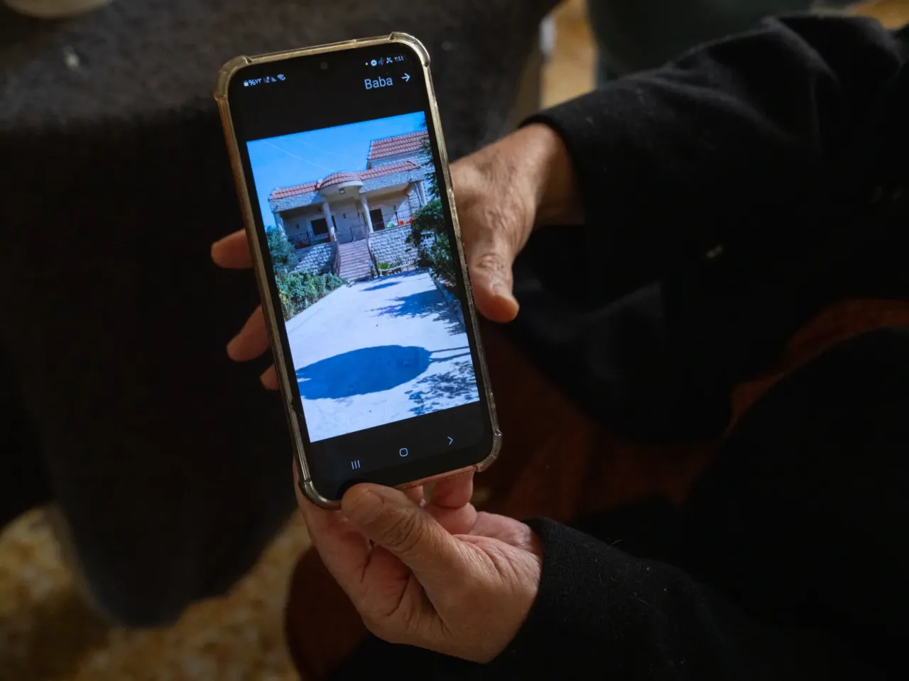 Born in south Lebanon, displaced to Beirut, two grandmothers reflect on Israeli invasions 2 Allawiya shows a photo of her home in Maroun al-Ras that was destroyed just over a year ago. The home has been destroyed and rebuilt after successive Israeli invasions in 2006 and 2024.