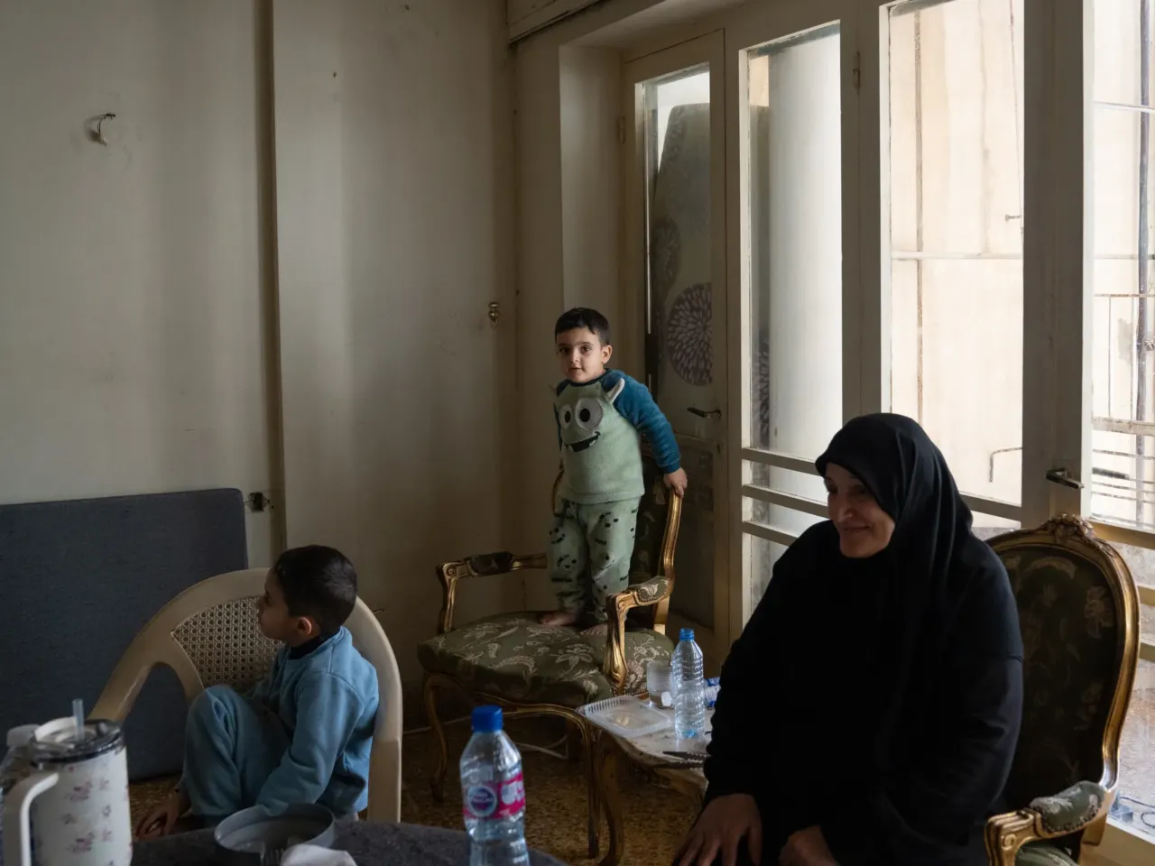 Born in south Lebanon, displaced to Beirut, two grandmothers reflect on Israeli invasions 4 Mohammad Atwi, 4, jumps on a chair in the apartment where his family is staying with dozens of relatives, including grandmother Kafa Wehbe (right), all displaced by Israeli attacks.