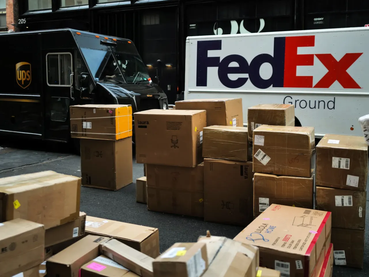 The hidden power keeping wages low 3 Parcels are seen in a street nearby UPS and FedEx trucks in a street of the Manhattan borough in New York City on December 4, 2023.
