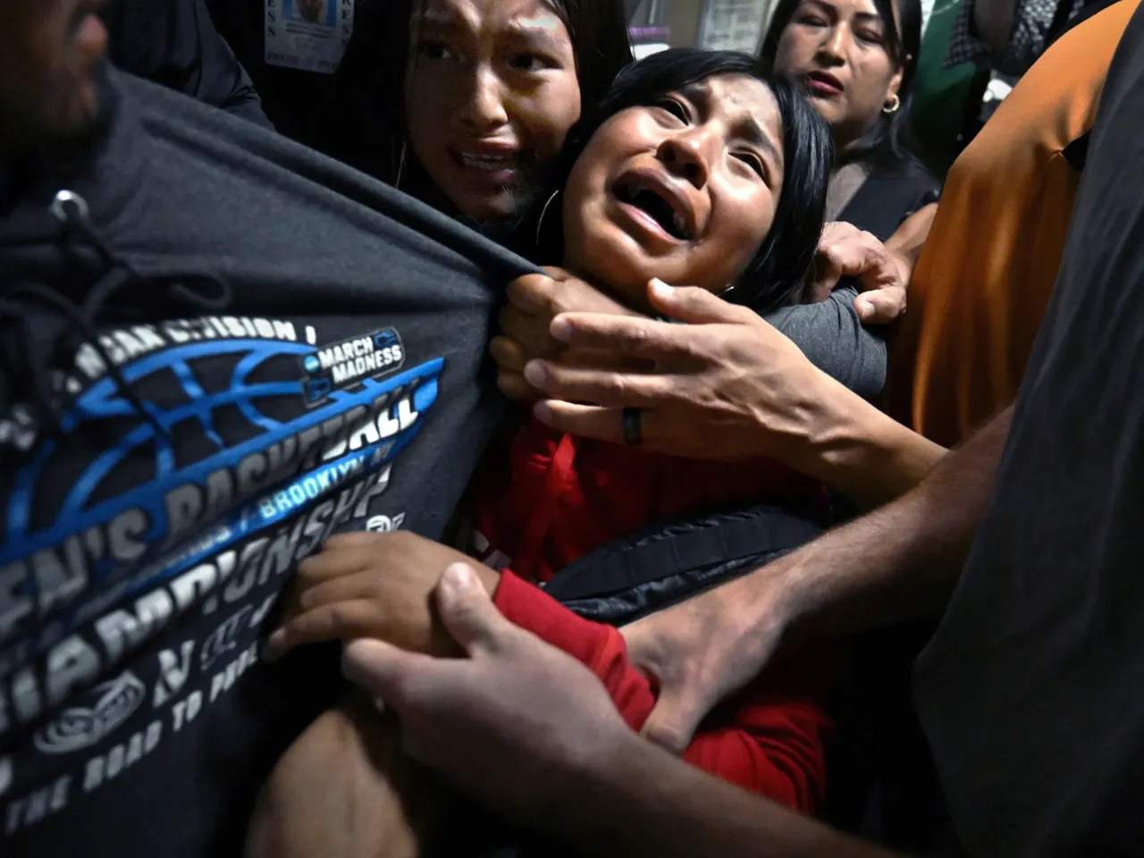 ​​Distraught girls cling to their father, Luis, as ICE detains him following an immigration hearing in New York City on Aug. 26, 2025. Luis was the sole breadwinner for his family.