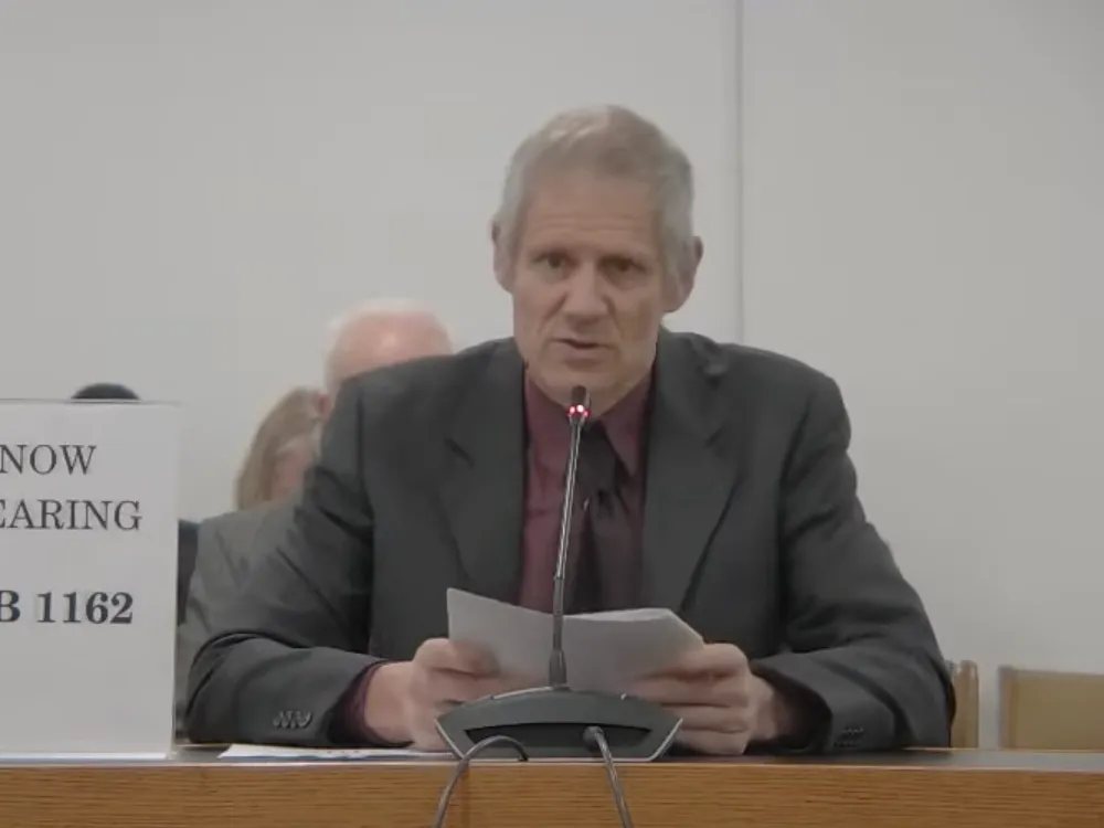 Germar Rudolf, a Holocaust denial activist from Germany, presented testimony to the New Hampshire state legislature in Jan. 2026. Rudolf told NPR that state Rep. Matt Sabourin dit Choinière, left, invited him to the legislative hearing on Holocaust education.