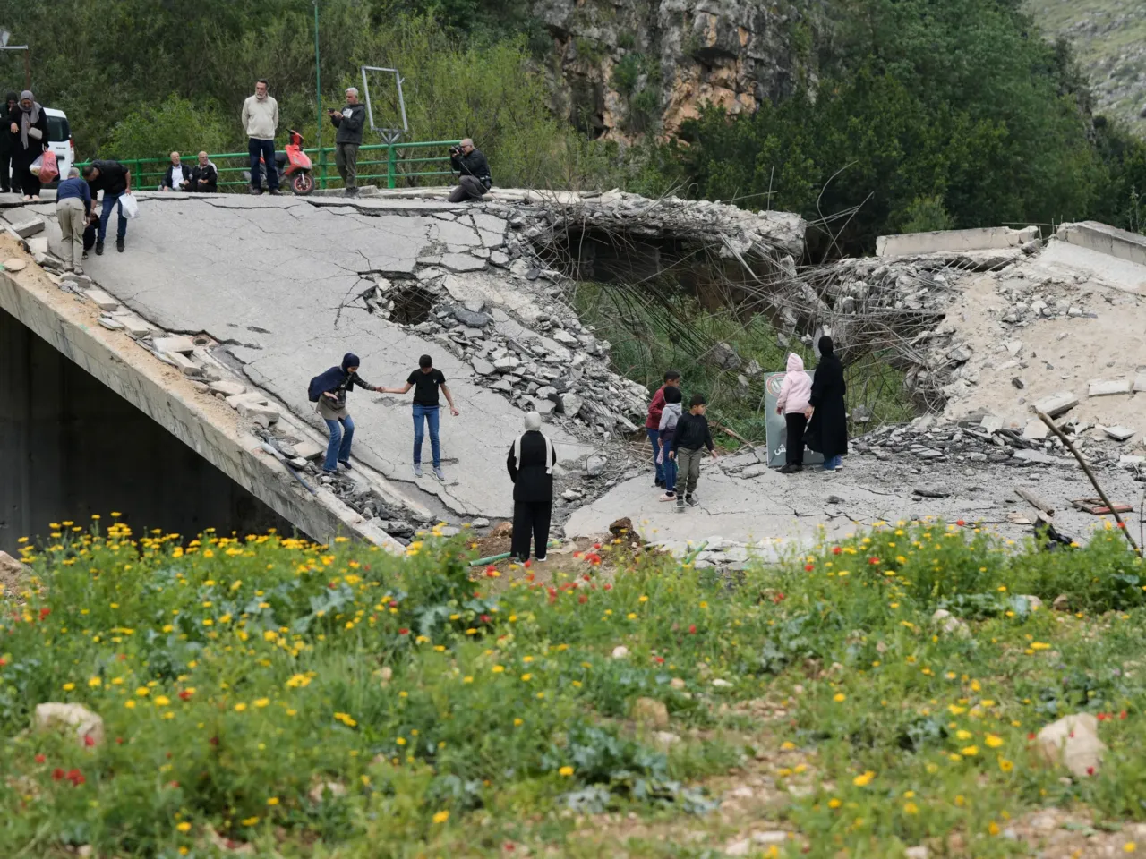 Mirroring Gaza, Israel is destroying towns and villages in southern Lebanon 1 Displaced people cross on foot over a destroyed bridge as they return to their villages following a ceasefire between Hezbollah and Israel, in Tayr Felsay village near the city of Tyre, southern Lebanon, April 19, 2026