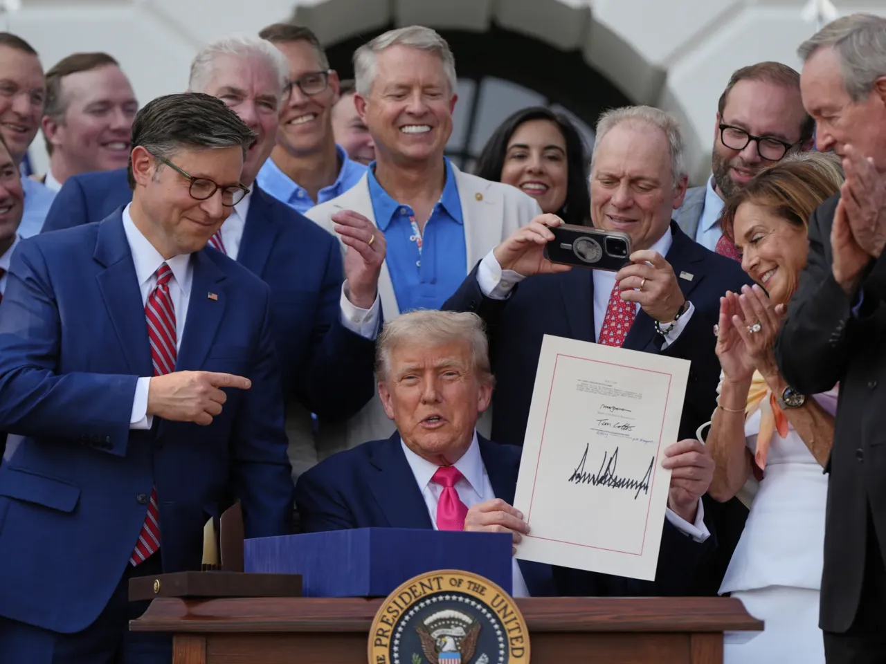 President Donald Trump and Republican members of Congress at the signing ceremony for his tax cut and spending bill on July 4, 2025. That law makes it a requirement for many adults who get Medicaid to prove that they are working.