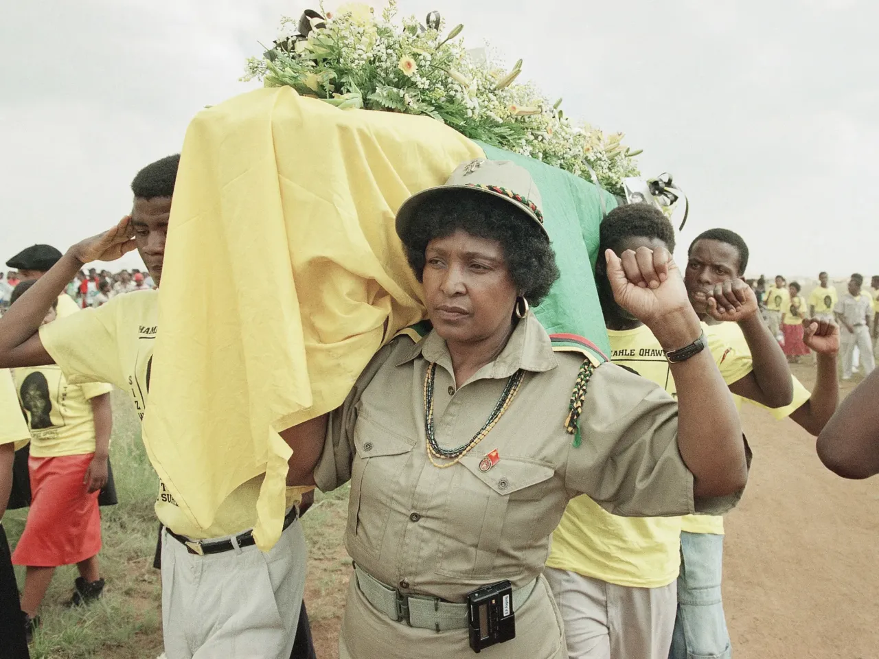 FILE: Winnie Mandela carries the coffin of Clayton Sithole in Soweto, Feb. 10, 1990 — hours before learning Nelson Mandela would be freed from prison. Sithole, boyfriend of her daughter Zinzi Mandela, died in police custody.