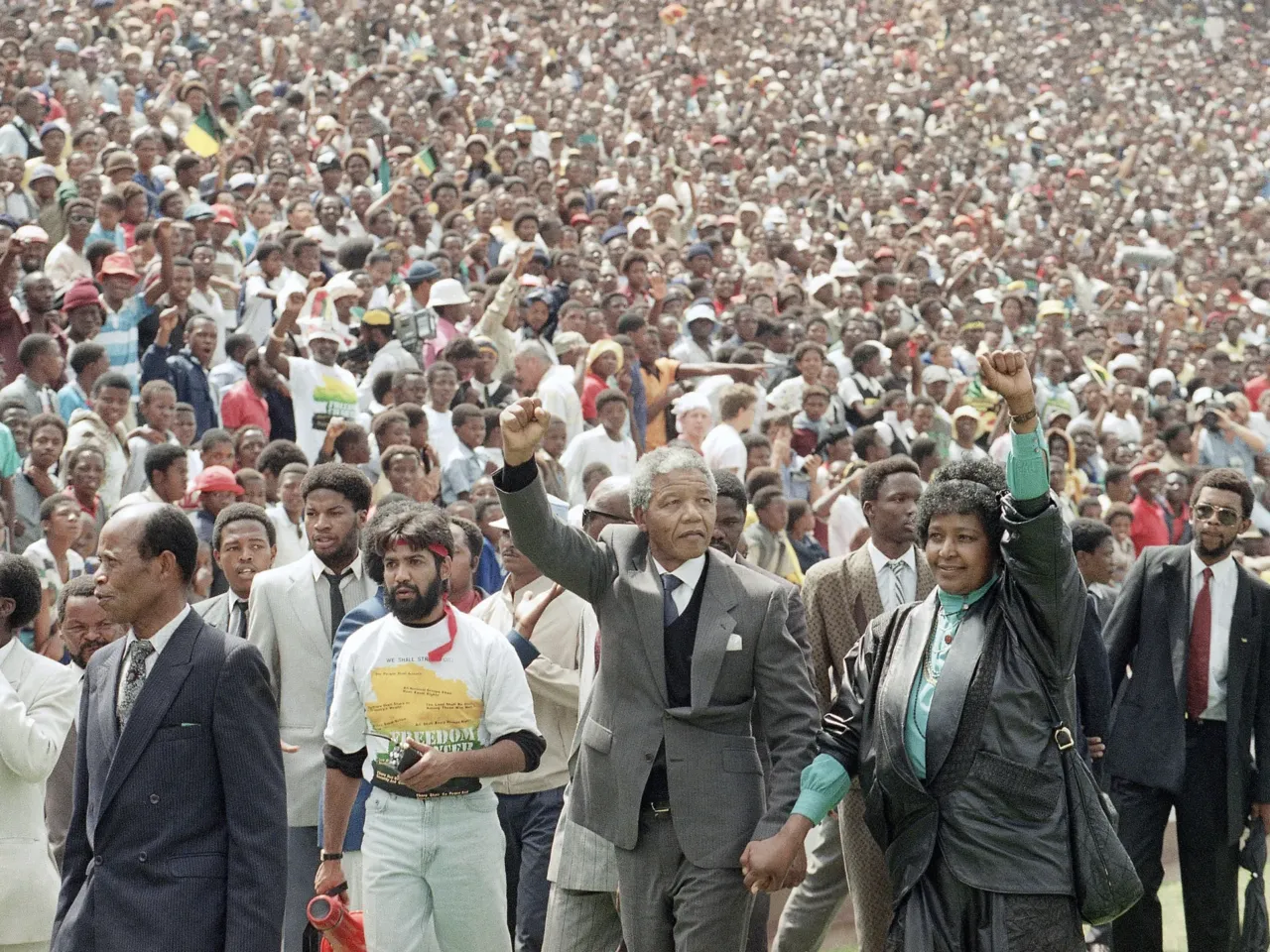 FILE Nelson Mandela and Winnie Mandela give Black power salutes as they enter Soweto's Soccer City stadium, South Africa Tuesday, Feb. 13, 1990. 120,000 thousand people packed the venue to hear his speech.