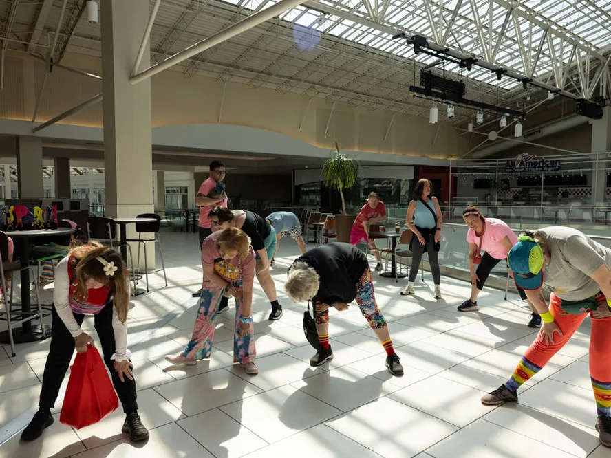 This flashy group of Portland mall walkers puts neon pep into their step 3 The Food Court 5000 mall walkers stretch before starting their rounds at the Lloyd Center food court.