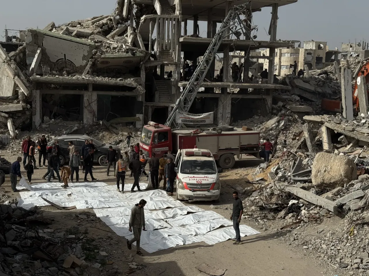 Skeletons in their clothing: Recovering bodies from the rubble in Gaza 1 White body bags hold the remains of people recovered from the rubble of an apartment building destroyed by an Israeli strike.