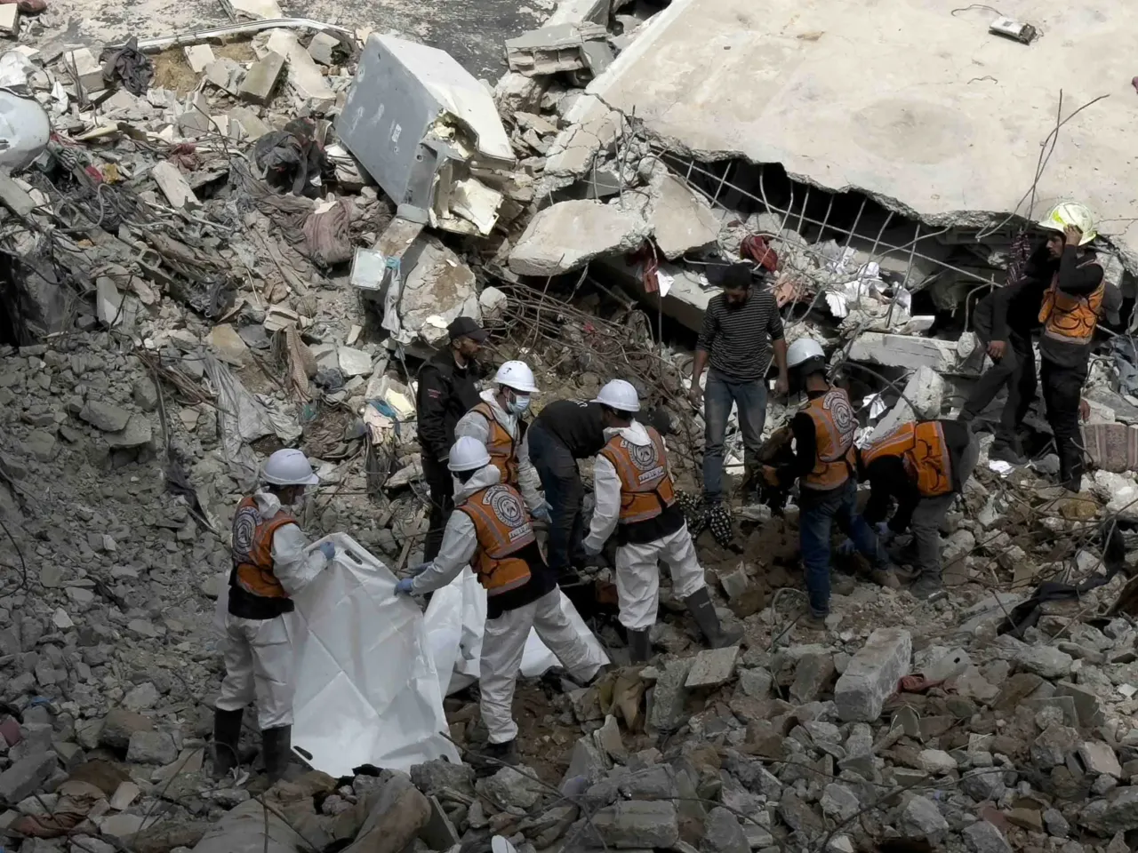 Skeletons in their clothing: Recovering bodies from the rubble in Gaza 8 Gaza civil defense crew members carry skeletal remains recovered from beneath the rubble of the Abu Naser family home.