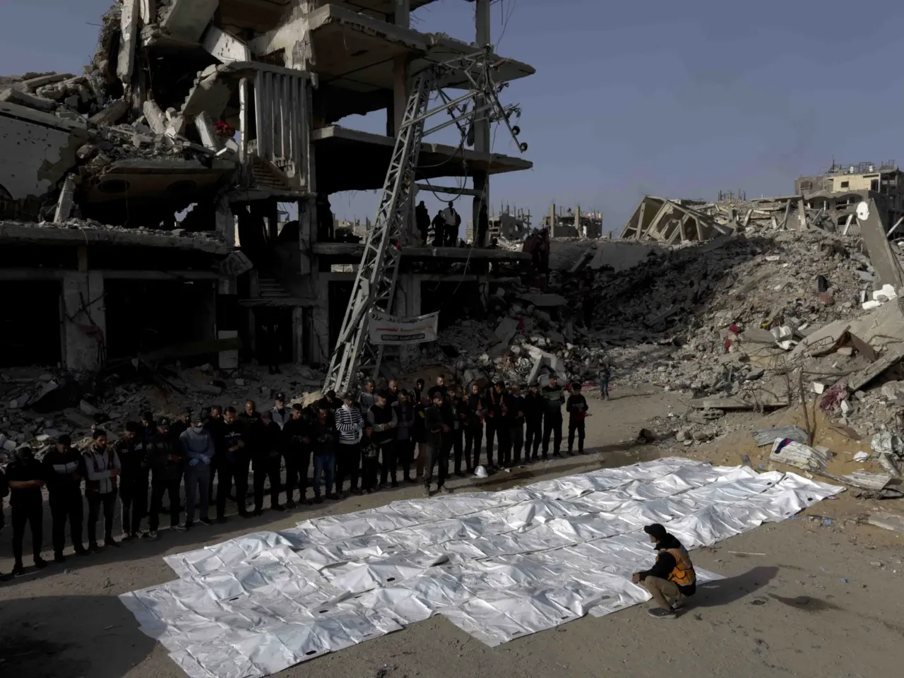 Skeletons in their clothing: Recovering bodies from the rubble in Gaza 11 At the end of a three-day search mission, family members, neighbors, and civil defense staff perform funeral prayers over the bodies of 50 members of the Abu Naser family recovered from beneath the rubble of their home destroyed in an Israeli strike in October 2024