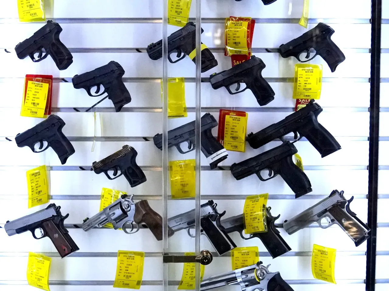 A study estimates that 32 million children live in homes with firearms, and a significant portion of those guns are not stored safely. Here, handguns are displayed at Kittery Trading Post, in Kittery, Maine.