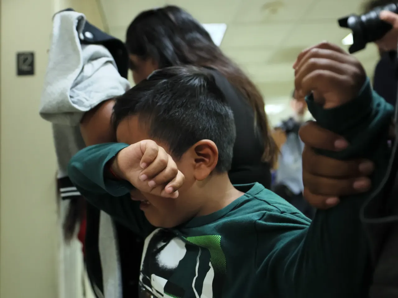 A child cries after his father is detained by federal agents as they left an immigration court hearing at the Jacob K. Javits Federal Building on August 26, 2025 in New York City. The Trump administration's immigration crackdown continues nationwide.