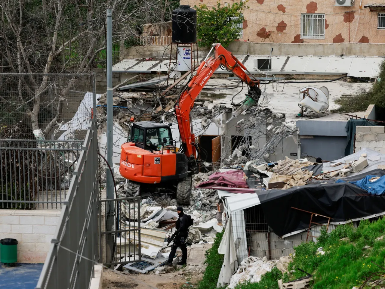 Israel's trying to expel a whole Palestinian district in East Jerusalem, activists say 1 An Israeli border policeman stands by as a bulldozer demolishes the house of Fakhri Abu Diab, in Silwan in East Jerusalem.