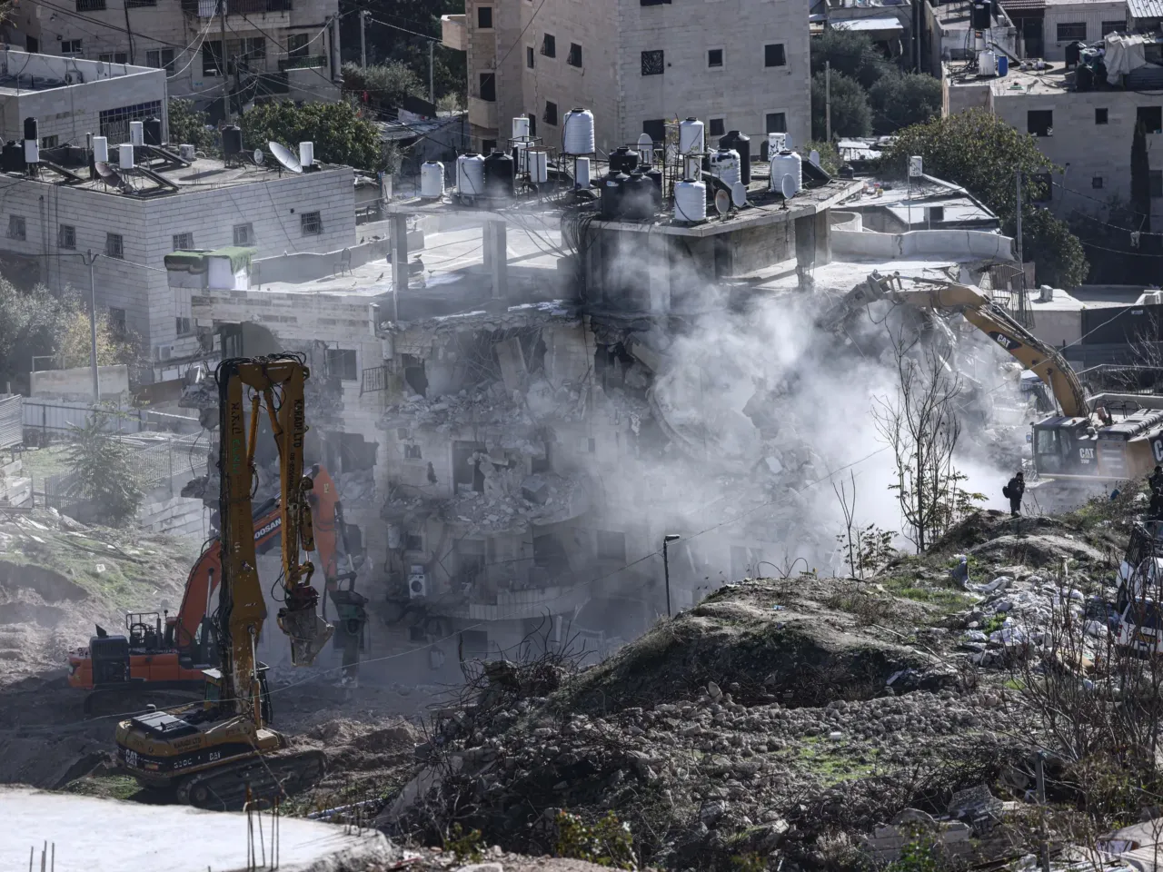 Israel's trying to expel a whole Palestinian district in East Jerusalem, activists say 3 Heavy machinery operates as Israeli forces demolish a residential building where Palestinian families lived, near the Silwan neighborhood of East Jerusalem.